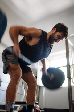 Man Doing Bent-Over Row Weightlifting Workout In Gym