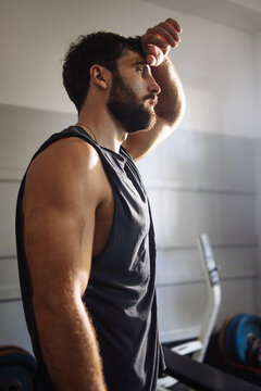 Fit Young Man Pausing Workout In Gym