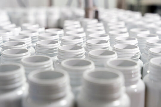White plastic bottles on manufacturing production line