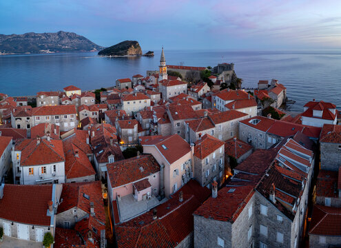 Historic old Town Budva With Red Roofs by the Sea after sunset
