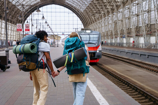 Backpackers at railway station before journey