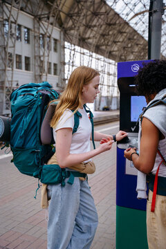 Backpackers at railway station before journey