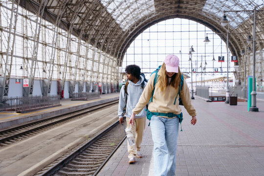 Backpackers at railway station before journey