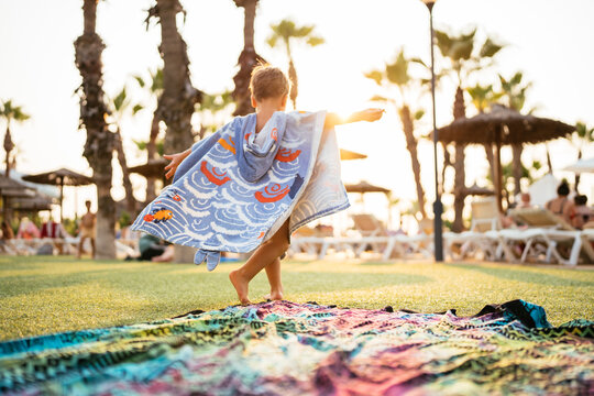 Boy enjoying summer vacation at resort during sunset