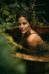 Fototapeta premium Woman bathing in a rustic wooden tub surrounded by lush forest greenery. Outdoor spa relaxation and wellness concept in nature. Serene woman enjoying a soak in a woodland setting.