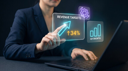 Fototapeta premium Businesswoman Tracks Revenue Targets on Laptop with Holographic Growth Charts to Analyze Quarterly Trends, Evaluate Margins, and Plan Strategy, Focusing on Financial Expansion and Market Gains