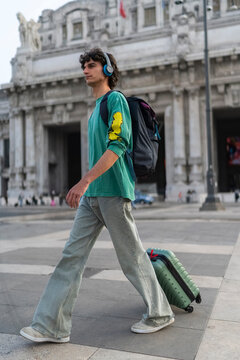 Gen Z guy walks in front of historic building in Italy