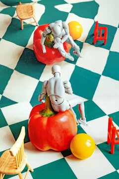 Figures interact with red bell peppers in a playful scene