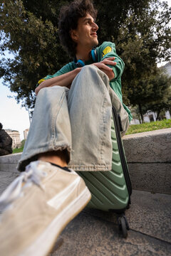 Gen z traveler enjoys a moment in Italy with a bag and trolley