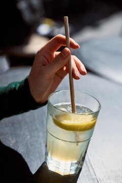 Enjoying a Drink With a Lemon Slice in Sunny Outdoor Setting