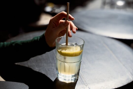Drink With Lemon Slice on Wooden Table in Afternoon Light