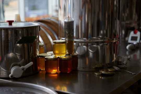 Honey jars and metal containers in a kitchen on a sunny day