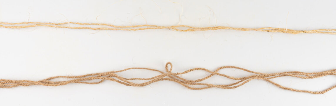 Twine rope piece isolated, jute loop fragment, beige packaging cord knots, old natural line cable