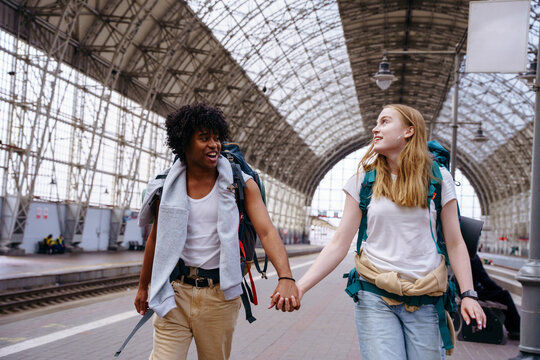Backpackers at railway station before journey