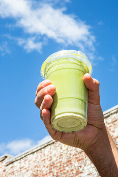 Male Hand Holding Green Matcha Drink