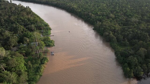 Aerial Shot of a Large Brown River, winding through a Tropical Rainforest. Kinabatangan River, Sabah, Borneo, Malaysia.
