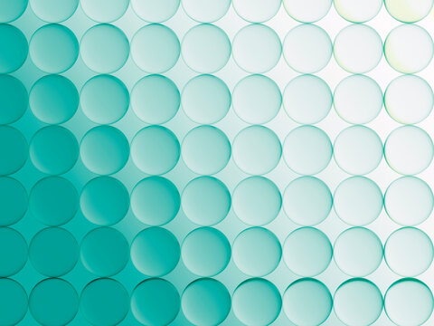 Circles Arranged in a Pattern on a Green Background With Light