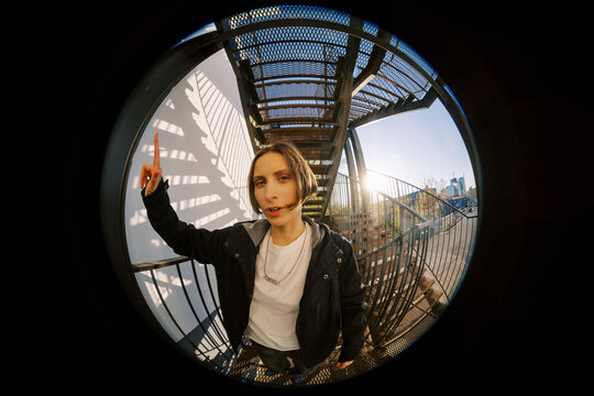 Person Standing on a Metal Staircase in the Afternoon
