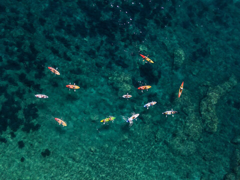top down drone shot group of kayakers in the  sea in summer