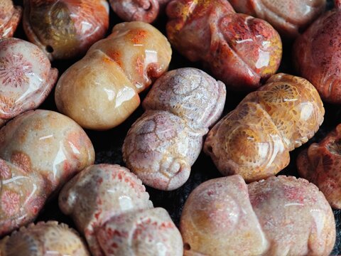 Colorful Carved Stones Are Arranged in a Display at a Market