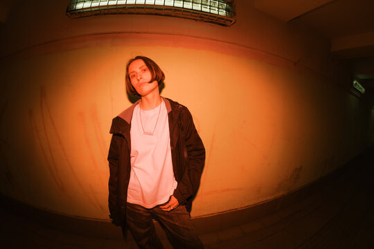 Young Person Poses in Dimly Lit Hallway During Evening Hours