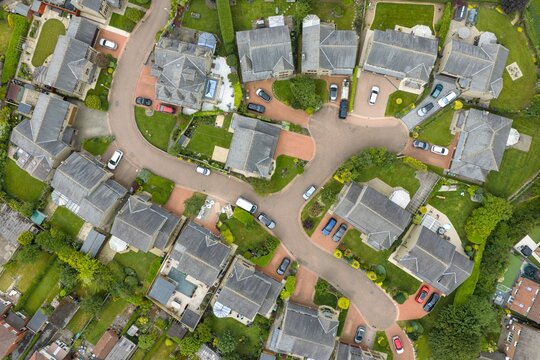 Aerial top down drone view of a residential cul de sac in Tingley Wakefield showing detached homes gardens roads and suburban neighbourhood layout in the summer time