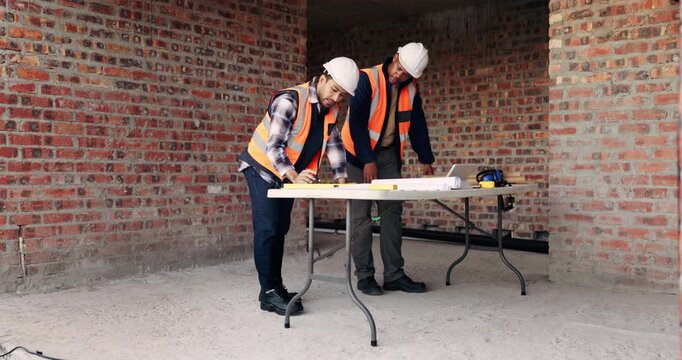 Planning, team or people with blueprint for construction, talk or infrastructure reinforcement idea. Review, renovation project or men with schematic for building remodel, chat or foundation upgrade