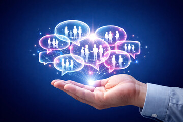 Obraz premium Businessman hand holds a floating holographic network of speech bubbles depicting human silhouettes as a symbol of digital communication and global social networking connection in a modern corporate.