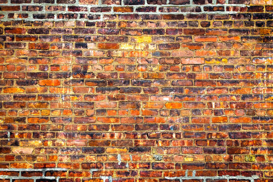 Old brick wall. Brickwork from an old brick in a rustic style. The structure and pattern of the destroyed stone wall.