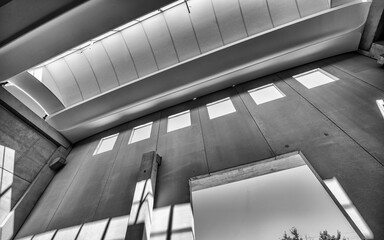 Naklejka premium Large unfinished industrial space featuring metal beam framework and raw warehouse construction interior details
