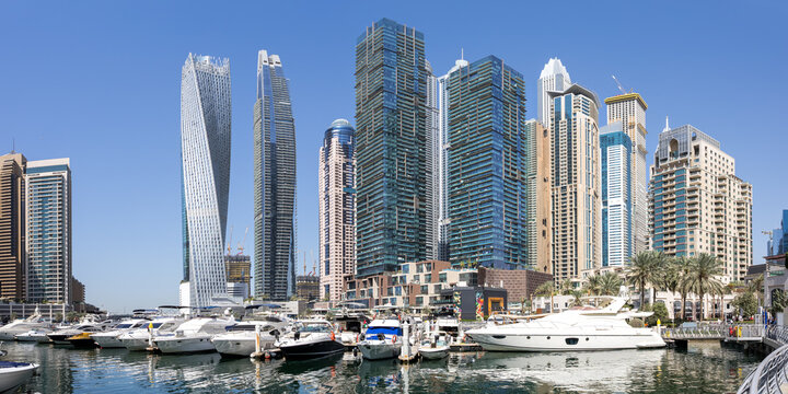 Dubai Marina skyline cityscape with yachts skyscraper buildings living at water panorama