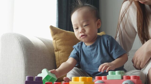 This image captures the joyful interaction between a child and an adult during playtime, emphasizing the importance of creative play for early development.