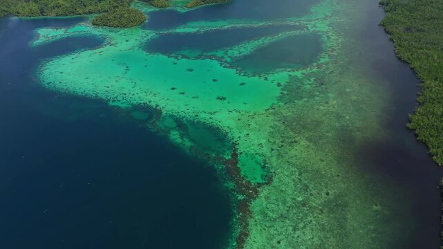 Epic cinematic tracking shot over majestic coastal landscapes of Banggai Sulawesi &ndash; Hidden tropical paradise islands with calm transparent lagoons, professional marketing video for travel tourism