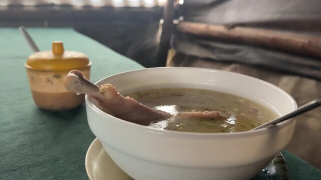 Steam rises from a steaming bowl of soup