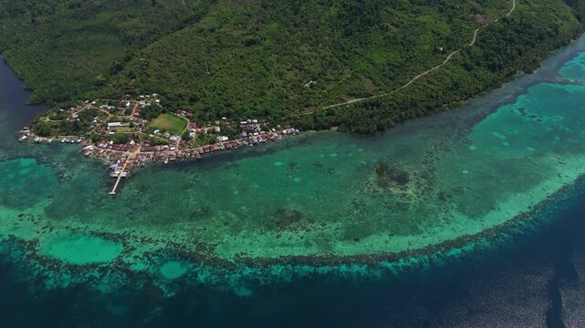 Epic cinematic tracking shot over majestic coastal landscapes of Banggai Sulawesi &ndash; Hidden tropical paradise islands with calm transparent lagoons, professional marketing video for travel tourism