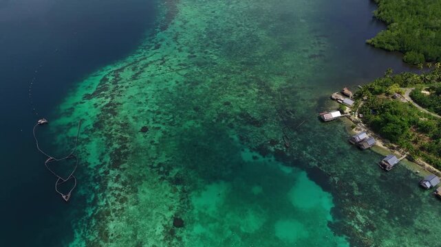 Epic cinematic tracking shot over majestic coastal landscapes of Banggai Sulawesi &ndash; Hidden tropical paradise islands with calm transparent lagoons, professional marketing video for travel tourism