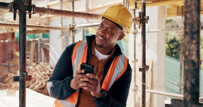 Black man, engineer and smile at phone on construction site for communication, funny joke and good review. Male architect, happy and tech on worksite for positive feedback, typing and comedy story