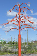 Naklejka premium Orange Functional tree, a striking 20-foot-tall pubic art sculpture, by Cuban artist Alexandre Arrechea, Toronto's Port Lands, right in front of the historic Old Fire Hall 30 (39 Commissioners Street)