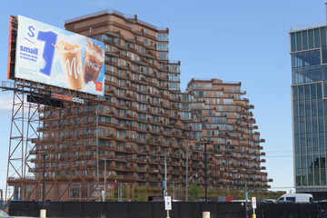 Naklejka premium McDonald's Canada spectacular billboard on an intricate steel truss work frame near Small St and Queens Quay E, with a stunning view of Aqualuna Condos, Toronto
