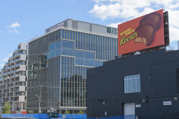 Fototapeta premium (l to r) Aquabella Condo Building, T3 Bayside, roadside spectacular billboard (Reese's) and old building on Queens Quay E, Toronto