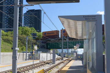 Fototapeta premium distant view of Main Line: CPKC Don Sub (Canadian Pacific Kansas City) looking east from Sunnybrook Park platform stop, Eglinton Line 5, Toronto