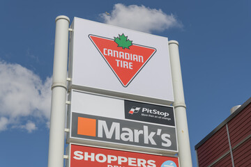 Fototapeta premium exterior pylon road sign for Canadian Tire, a department store, and other businesses located at 1025 Lake Shore Blvd E, Toronto