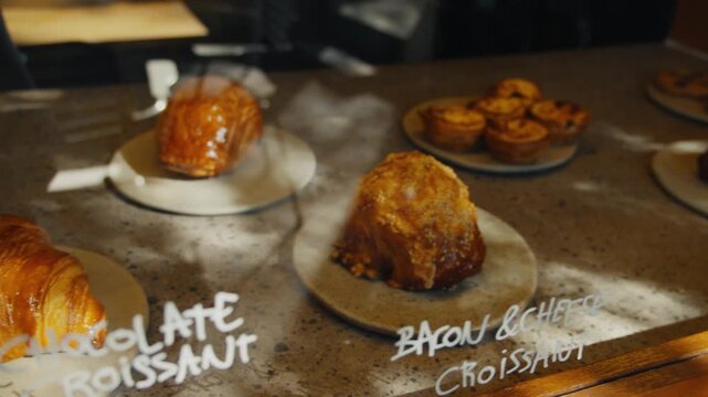 Fresh croissants and pastries in a bakery display case