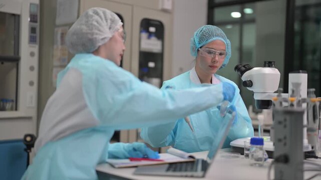 Scientists work in a laboratory conducting research and analyzing samples during the day