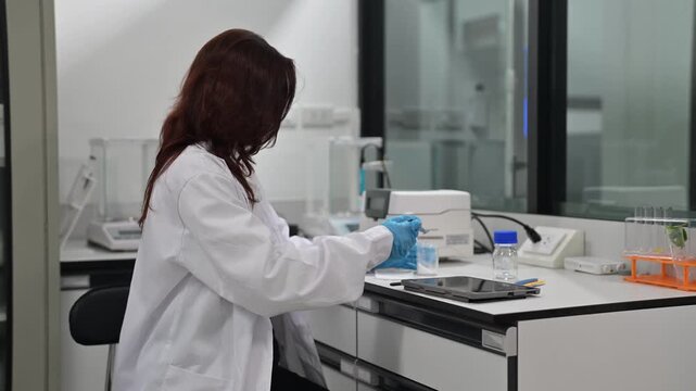 Scientist works in a laboratory setting with equipment and samples during a research session