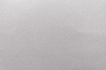 Close-up of a blank, textured gray paper surface with subtle shadows. © Rawpixel.com