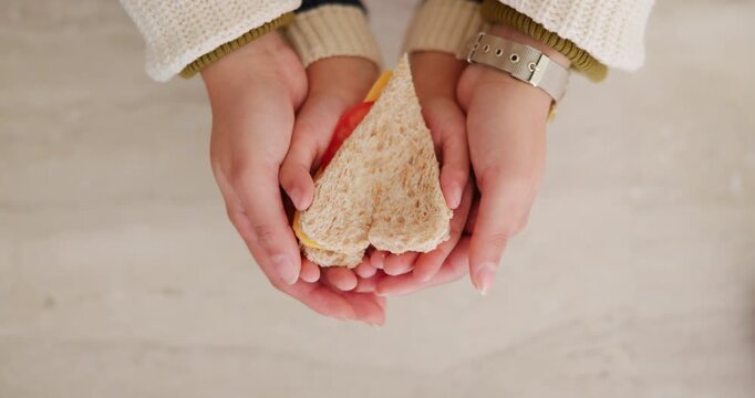 Hands, parent and child with heart for sandwich, bonding and love with nutrition for wellness in home. People, mother and kid with bread, food and above with symbol, support or sign at family house