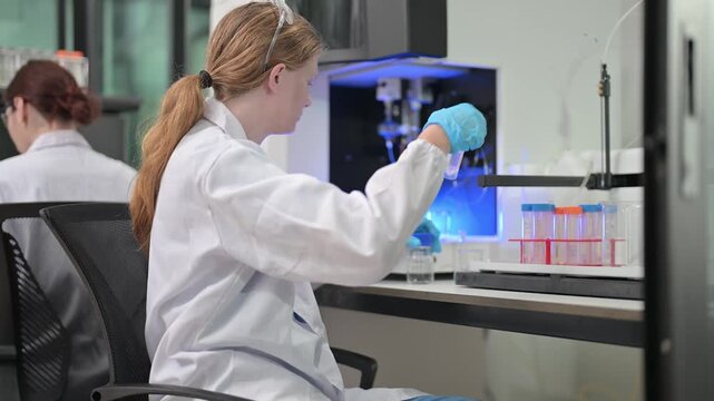 Scientist in lab coat conducting experiment with test tubes and equipment