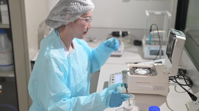 Scientist in protective gear meticulously performs measurements with laboratory equipment