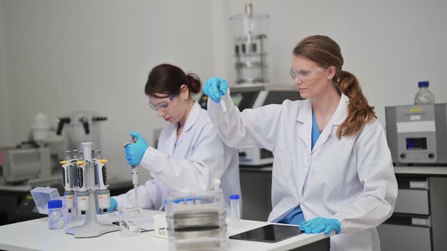 Chemistry experiment in laboratory with scientist working at the bench with glassware